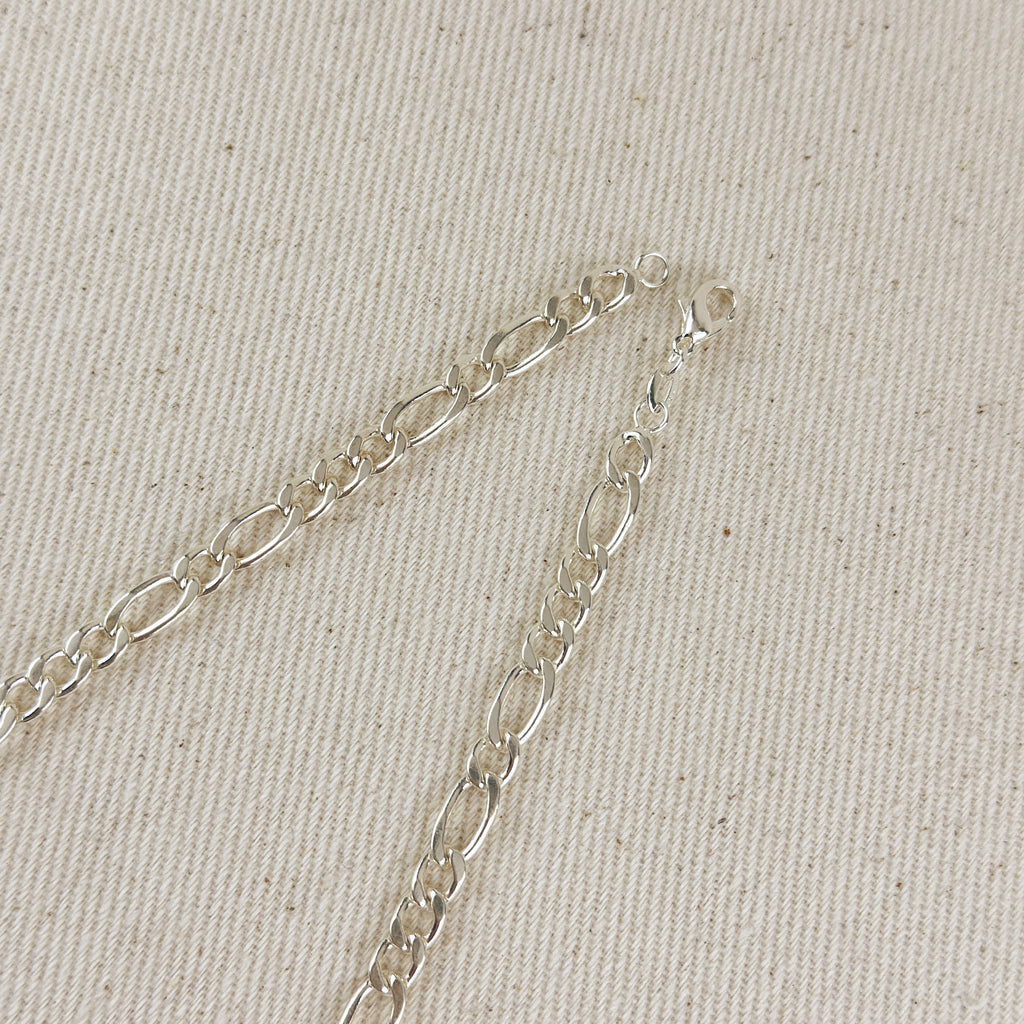 Silver chain bracelet on a beige fabric background