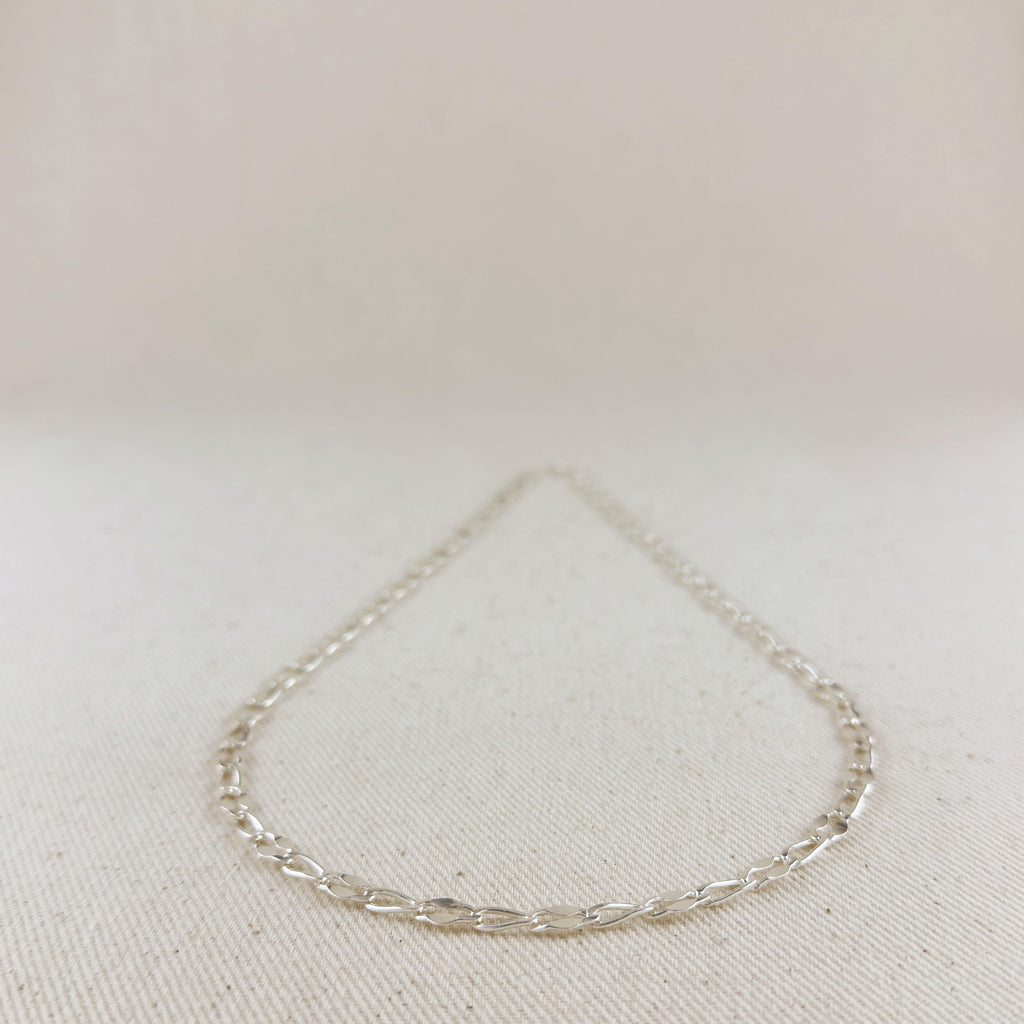 Silver bracelet on a light beige fabric background