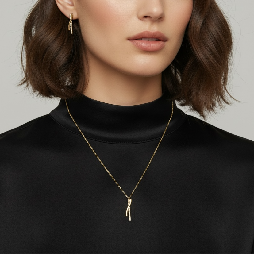 Woman wearing a black turtleneck and gold necklace with a minimal background