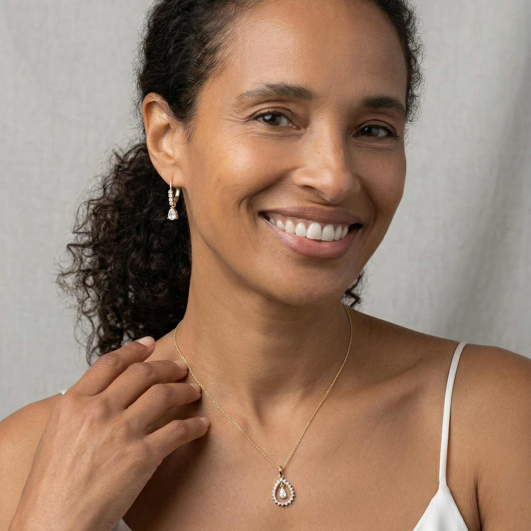 Woman wearing a necklace with a plain background