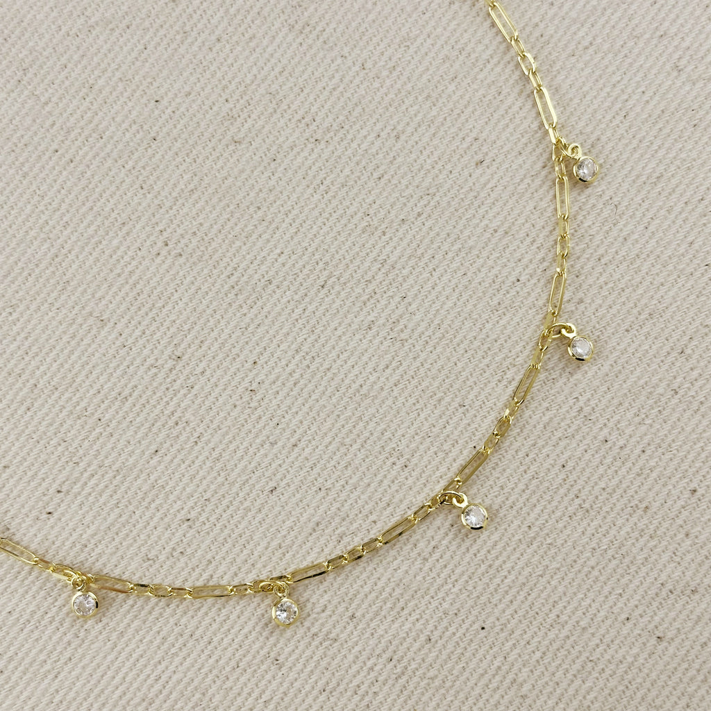 18K gold filled paperclip chain necklace with bezel set CZ drops, showcasing modern elegance and geometric design.
