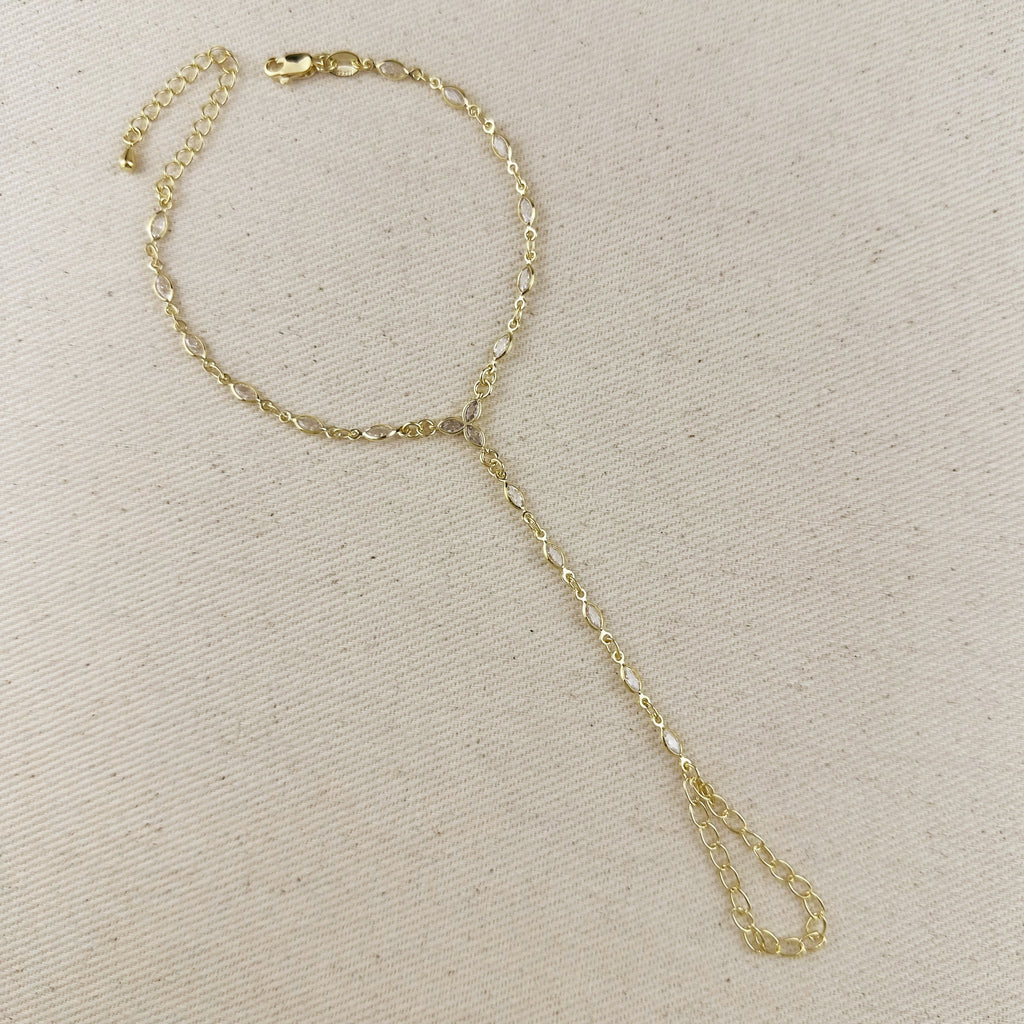 Gold chain bracelet on a beige background