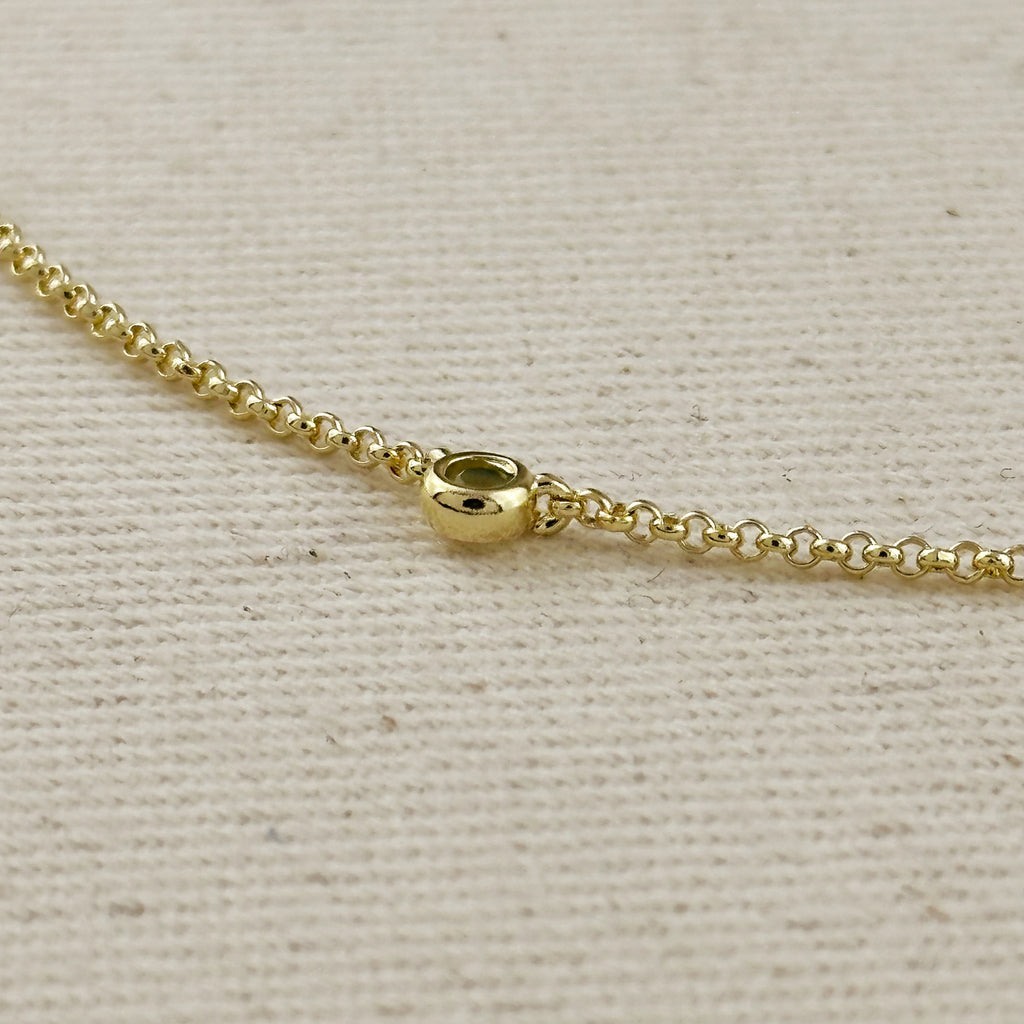 Close-up of a 18k gold filled chain necklace showcasing a round clasp detail.