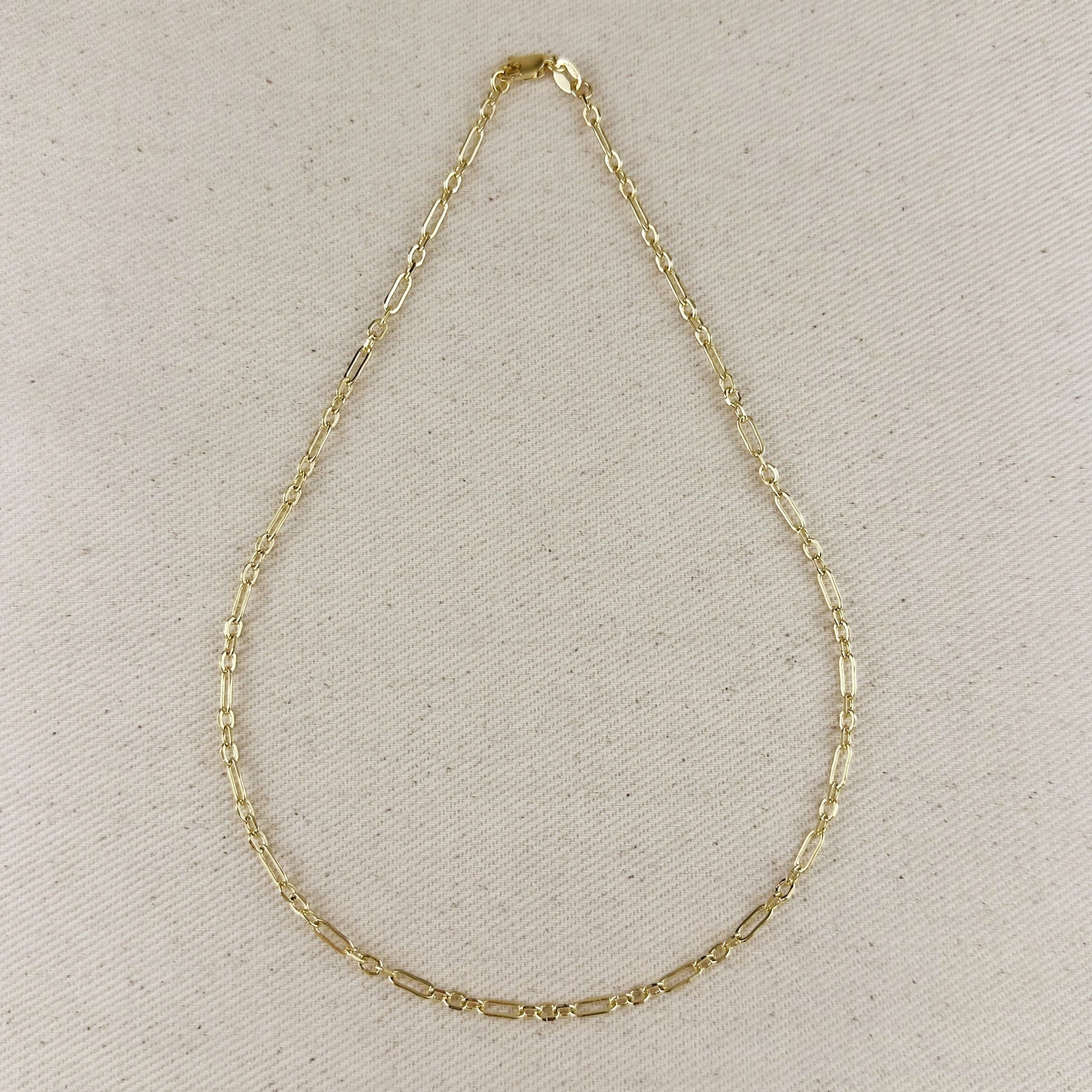 18k gold filled paperclip necklace with 3x1 link pattern on a neutral background.