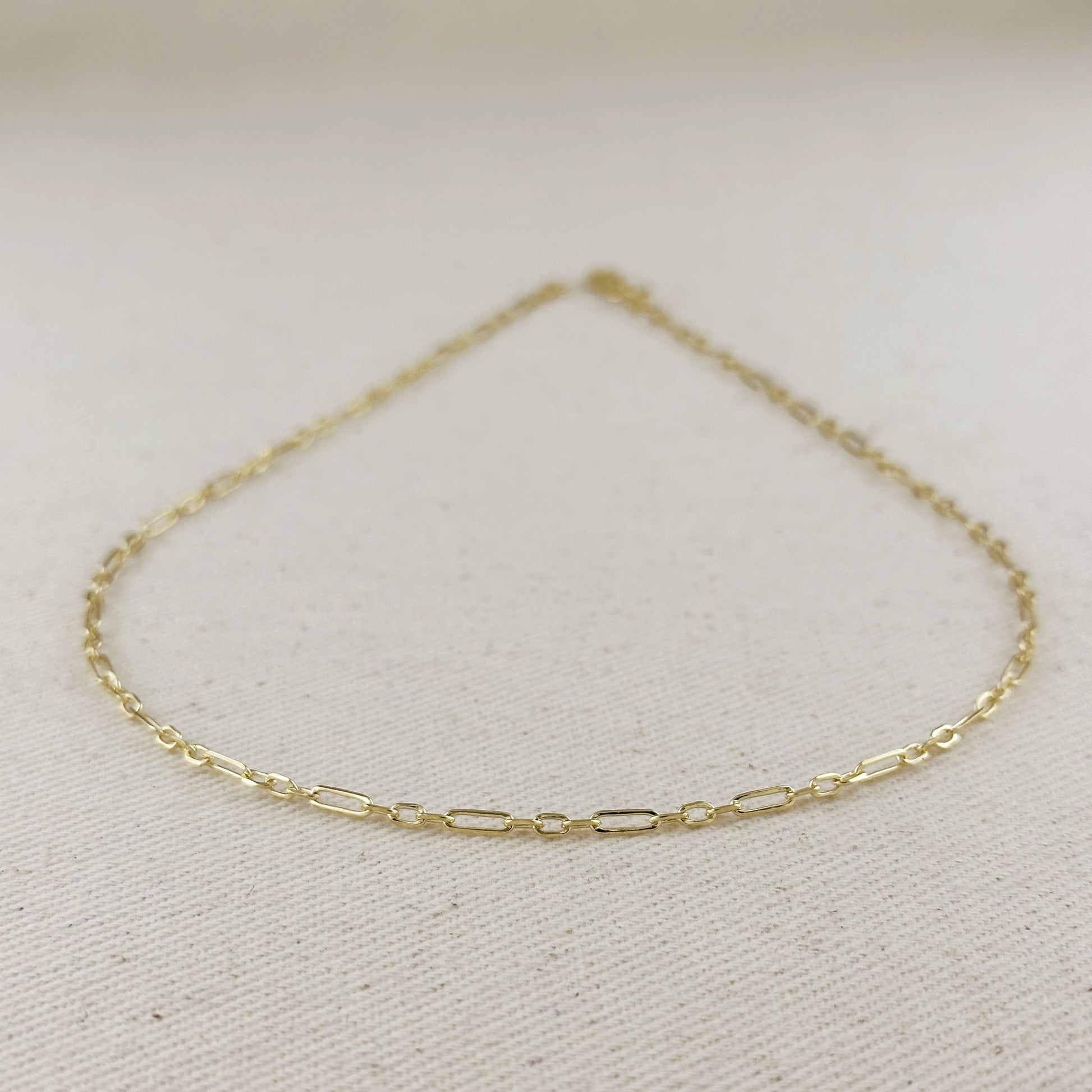 18K gold filled 2.1mm paperclip necklace with 3x1 alternated links on a neutral background.