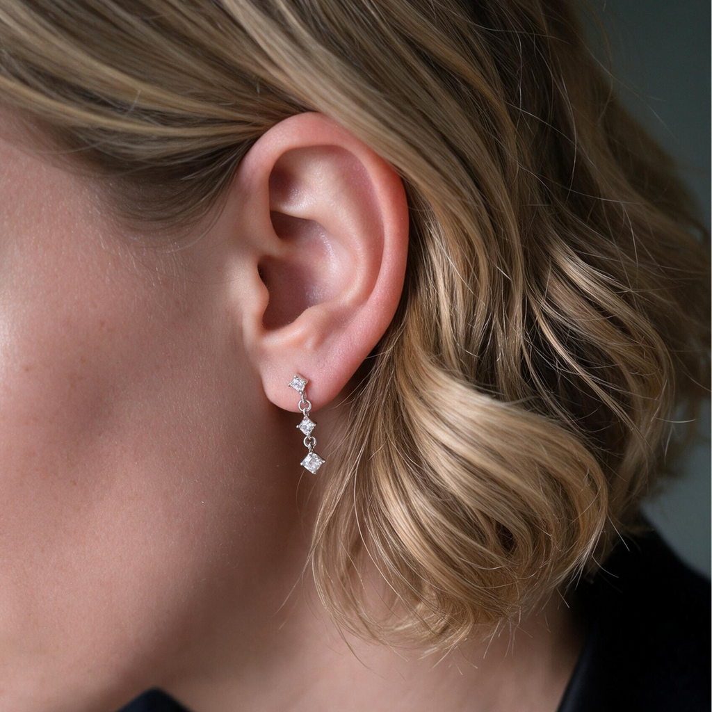 model with dangling silver earrings
