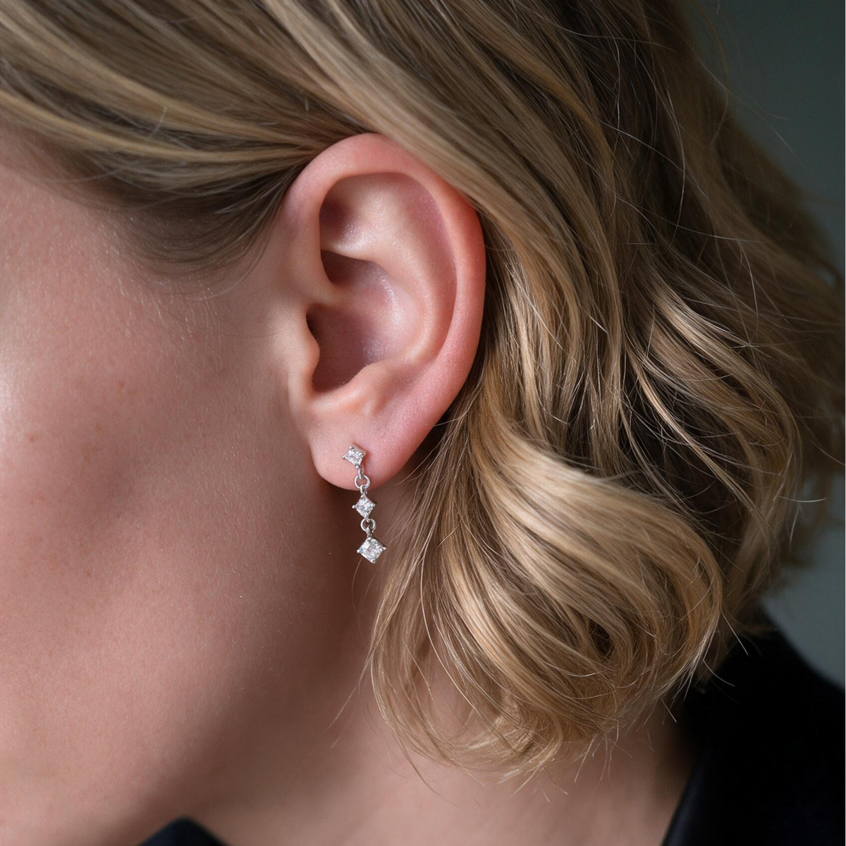 model with dangling silver earrings
