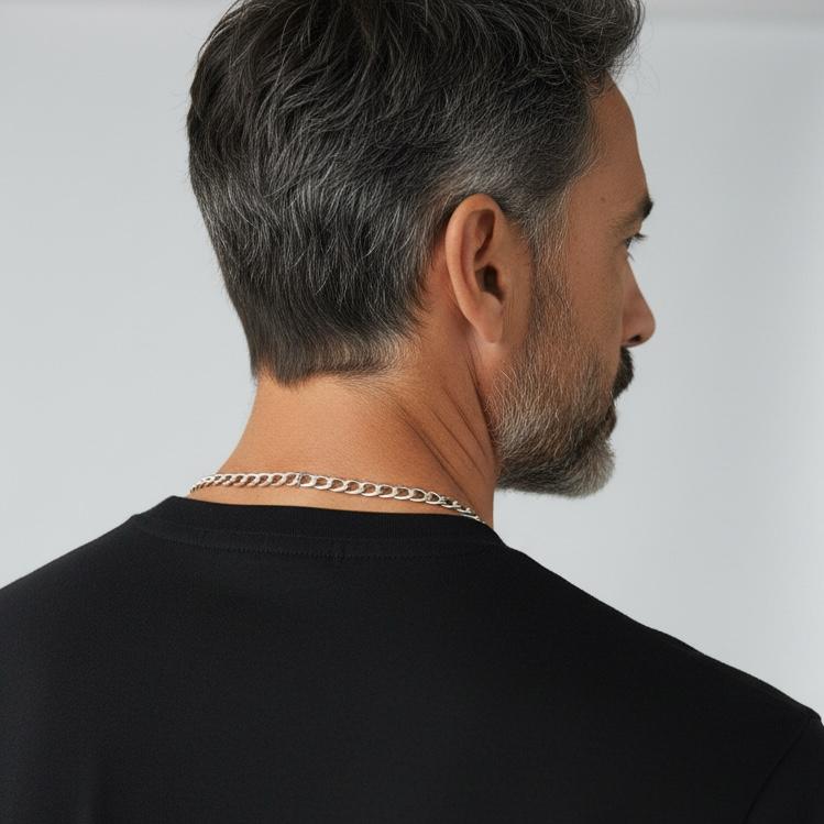 Man wearing a black t-shirt with a neutral background