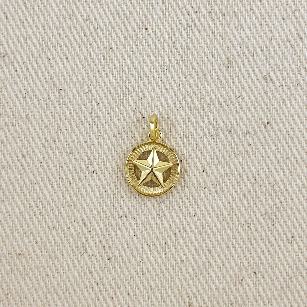 Gold star pendant on a beige fabric background