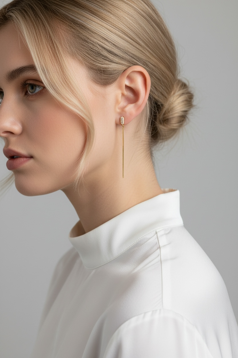 Woman wearing a gold earring with a plain background