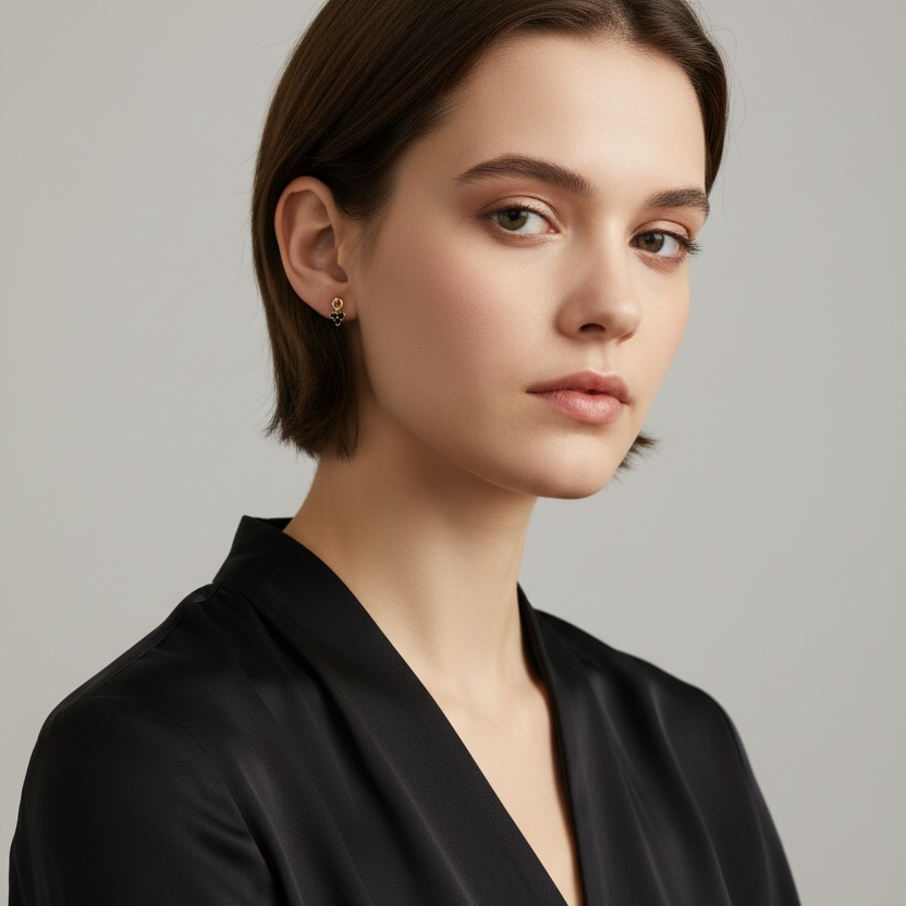 Woman wearing a black top against a plain background
