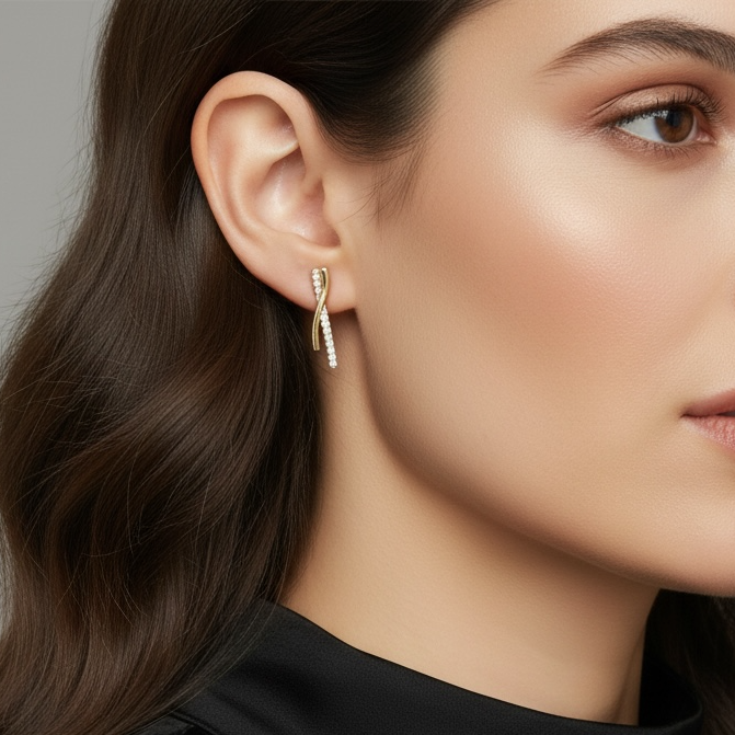 Close-up of a woman wearing gold earrings against a neutral background