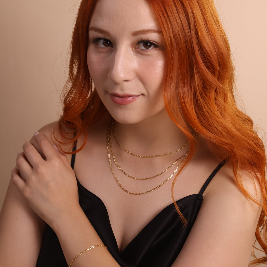 Model showcasing an 18K gold filled paperclip necklace and bracelet, featuring a contemporary style and elegant look.